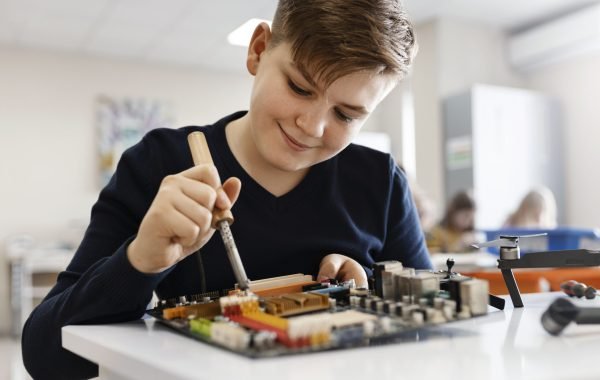 boy-repairing-electronic-component